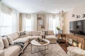 Welcome to #BohoPlayce. This living room has a sofa and 55" smart tv (no cable) 