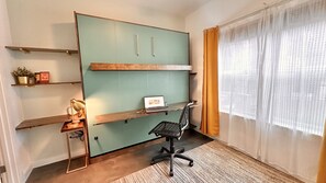 1st floor office/bedroom.  King sized Murphy bed with 2 drop down desks & chair