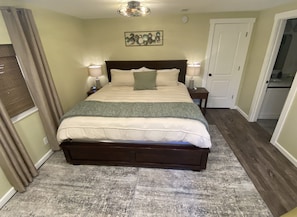 Master bedroom with king bed, smart TV. and en suite bathroom.