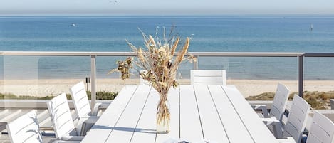 A stunning rooftop showcases an al fresco dining setting, beautiful views of the bay’s coastline, and a salty sea breeze.