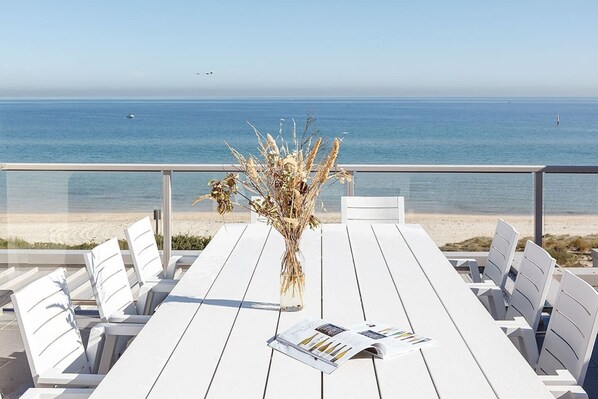 A stunning rooftop showcases an al fresco dining setting, beautiful views of the bay’s coastline, and a salty sea breeze.