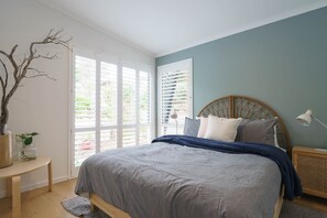 The elegant and contemporary master bedroom features a queen-size bed. 