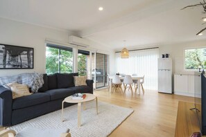Guests can settle in on the sofa with a book in the light and airy living area.  
