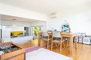 The open-plan dining area offers a four-seater table with stunning water views. 
