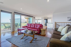 The open-plan living area upstairs features two comfy sofas and an indoor fireplace, offering the perfect spot to settle in with a movie after a day of sun and sightseeing. 
