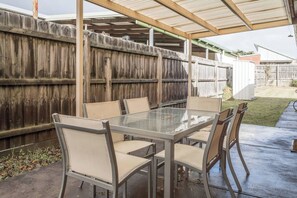An alfresco dining area allows you to enjoy the crisp coastal area while sharing a meal outdoors.