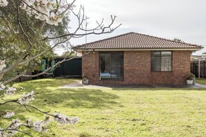 A large leafy backyard is perfect for families, with plenty of space for kids to play.
