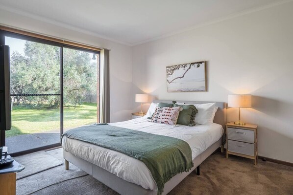 The second bedroom has a lovely leafy outlook and comes with a queen-sized bed and own TV.