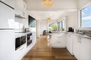 The modern, open-plan kitchen has all you need to prepare meals at home. 

