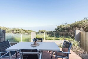 A private back deck with an outdoor table offers a relaxed space for alfresco dining, all while enjoying expansive outdoor views. Pets are also welcome to join the fun!