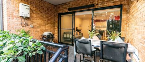 A private patio boasts lovely green outlooks and a BBQ, perfect for cooking up a storm and hosting guests.