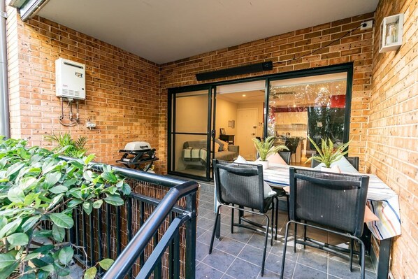 A private patio boasts lovely green outlooks and a BBQ, perfect for cooking up a storm and hosting guests.