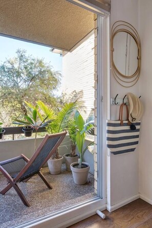 A quaint balcony allows a light-filled, breezy space and has outdoor seating where you can sip your morning coffee.