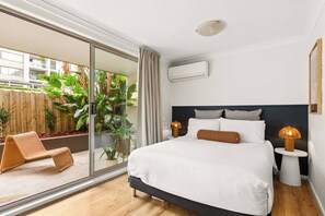 Unwind in the bed area, which connects effortlessly to the balcony and the entire living space. 
