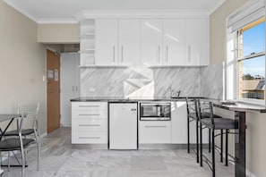 The kitchenette has an induction stove, microwave and bar fridge for easy meals at home. 

