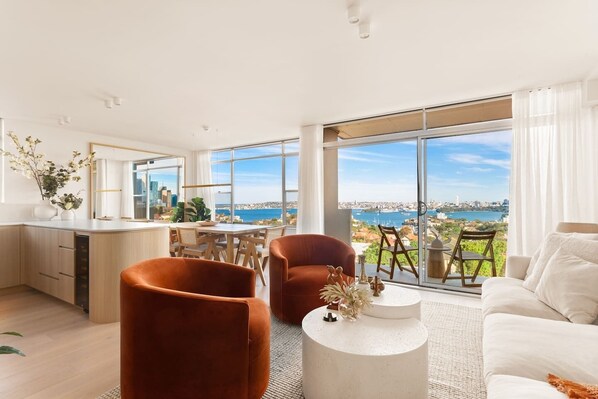 Immerse yourself in the beauty of Sydney's iconic harbour from the comfort of this stylish living room. 