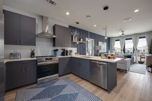 Fully equipped kitchen stocked with your basic cooking essentials, stainless-steel appliances, and breakfast bar seating.