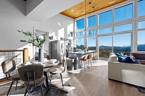 Open concept living area with soaring windows