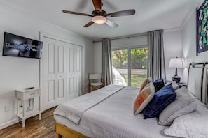 Primary Bedroom with King Bed, TV, Blackout Curtains and Direct Access to Patio