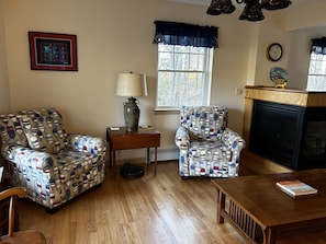 Living Room: Two comfortable chairs and the gas fireplace on the right of photo