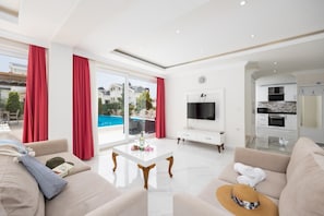 Living room with sofas, dining area, A/C, WiFi internet, and satellite TV