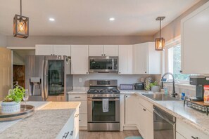 Full Kitchen with Stainless Steel Dishwasher, Stove, Oven, and Refrigerator