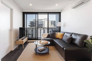 Relax in this air-conditioned living area, set with an L-shaped leather lounge fronting a central TV.