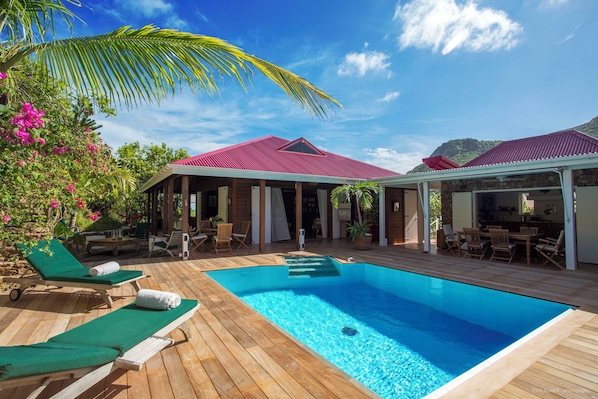 Terrace around the pool, deckchairs, parasol, barbecue, beautiful pool.