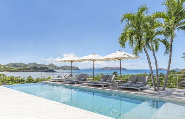 Large heated pool on the main level, smaller heated pool on the lower level, ideal for kids. Large teak terrace, with deckchairs. Outdoor dining and lounge areas. Gas barbecue.