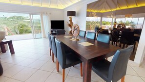 Indoor dining area next to the living room with the table for 8 guests. Outdoor dining table next to the pool. 