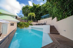 Pool, sun-beds, outdoor dining table, charcoal barbecue.