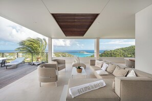 Outdoor living-room on the covered terrace by the pool with sofas for eight people.