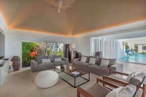 Interior living-room with ceiling fans, HD-TV with Dish Network, DVD player, surround sound system (also near the pool and outside), telephone.