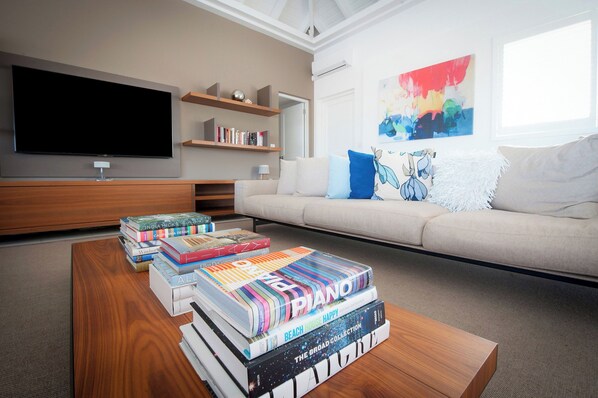 Living room opening entirely onto the pool terrace, air conditioning, ceiling fans, HD-TV, Dish Network, Apple TV, Sonos Bluetooth speaker, telephone, WIFI.
