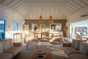 Living room opening entirely onto the pool terrace, air conditioning, ceiling fans, HD-TV, Dish Network, Apple TV, Sonos Bluetooth speaker, telephone, WIFI. 