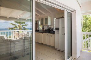 Located on the lower level. Equipped for eight people. Air conditioning, fan, breakfast bar with three stools, small cupboard, mosquito nets, fridge, freezer, oven, dishwasher, microwave, espresso and Nespresso coffee machine, blender, electric kettle, to