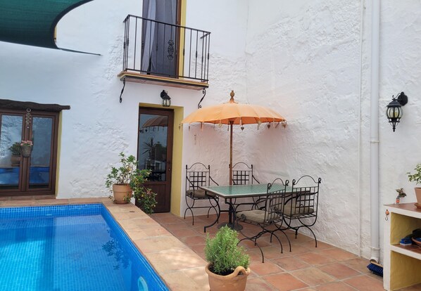 Outdoor courtyard dining in the shade of umbrella