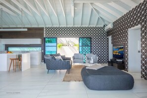 Great room with ceiling fan, HD-TV, Dish Network. The living room opens onto the terrace and the views.