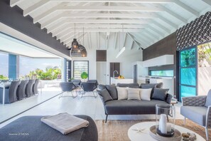Great room with ceiling fan, HD-TV, Dish Network. The living room opens onto the terrace and the views.