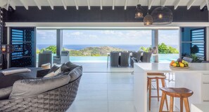 Great room with ceiling fan, HD-TV, Dish Network. The living room opens onto the terrace and the views.