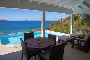 Lounge and dining areas on the covered terrace. Ocean view. 