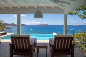 Lounge and dining areas on the covered terrace. Ocean view. 