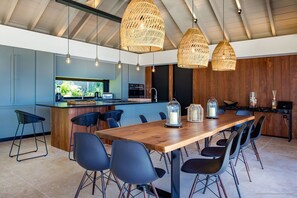 Indoor dining area with dining table for twelve people. Outdoor dining area near the pool, sofas and a rectangular wooden table covered with a parasol. Breathtaking views. 