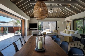 Indoor dining area with dining table for twelve people. Outdoor dining area near the pool, sofas and a rectangular wooden table covered with a parasol. Breathtaking views. 