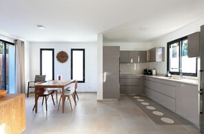 Fully equipped and air-conditioned kitchen, with electric oven, electrical stove, fridge and freezer, dish washer, microwave, toaster, electrical kettle, Nespresso and regular coffee machine, blender. Indoor table for 4 guests. Outdoor dining table.