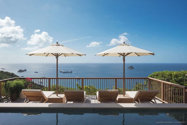 Located on a lower lowel. Nice pool, expansive terrace with loungers and deck chairs.