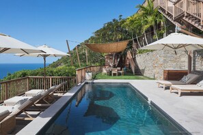 Located on a lower lowel. Nice pool, expansive terrace with loungers and deck chairs.