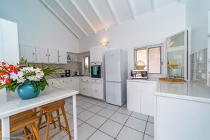 Fully equipped kitchen with breakfast bar for 4, electric oven, gas stove, microwave, dishwasher, regular coffee machine, fridge and freezer, toaster, electric kettle. Charcoal BBQ on the terrace. Indoor dining area, and dining table for 6 people on the c