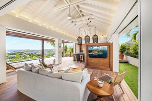 Great room, with open-air floor plan.  HD-TV, Apple TV. The living room opens onto the terrace and the views. 