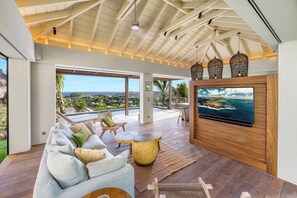 Great room, with open-air floor plan.  HD-TV, Apple TV. The living room opens onto the terrace and the views. 